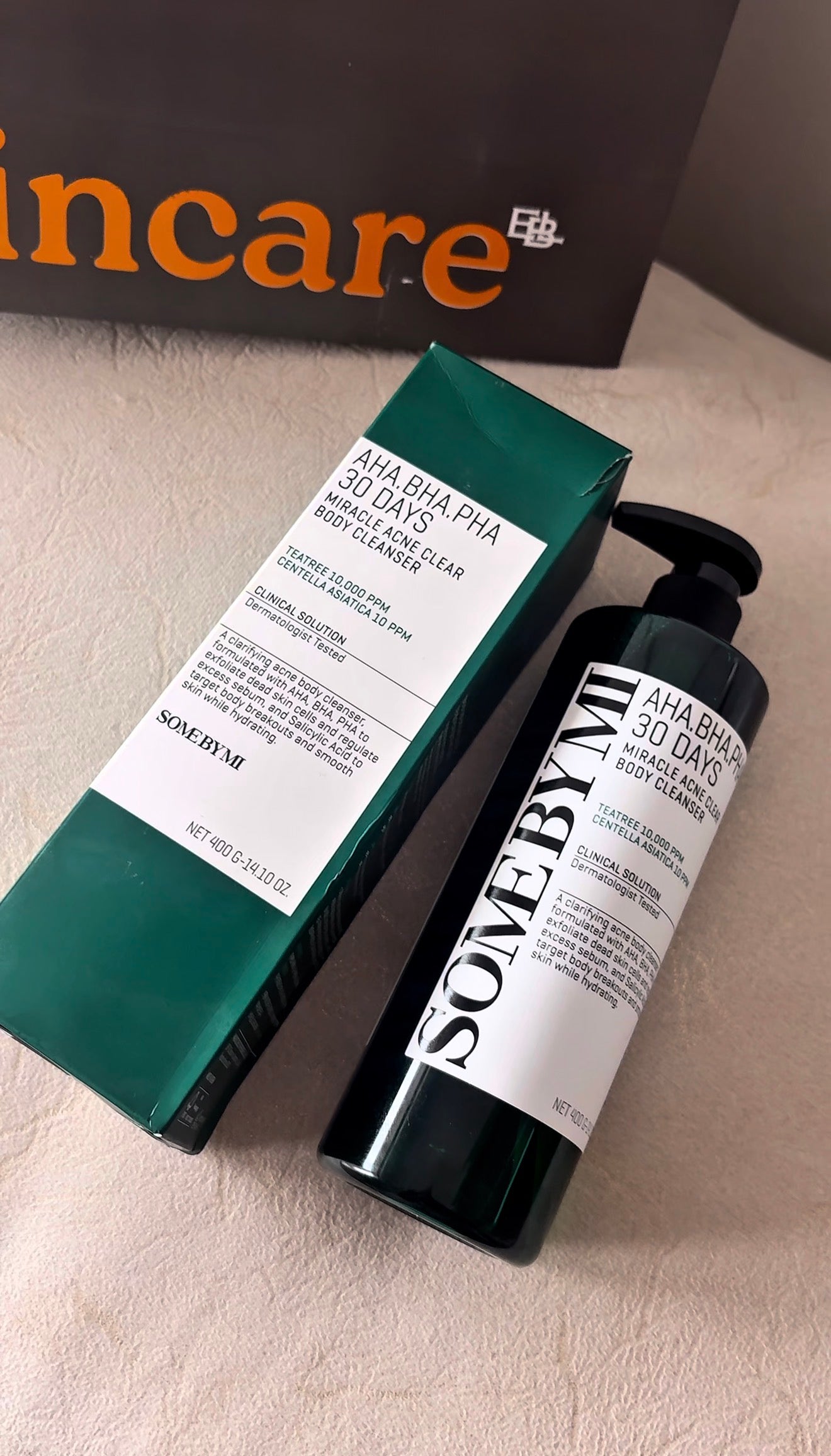 SomeByMi skincare product with packaging on a beige surface