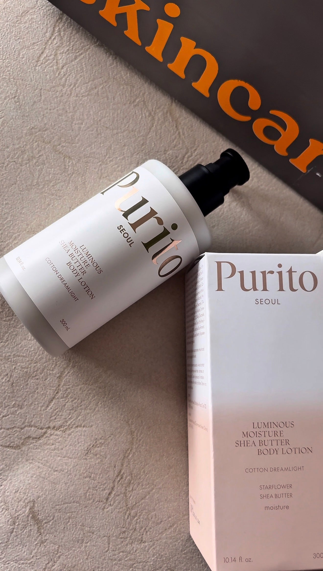 Purito skincare product with packaging on a textured surface
