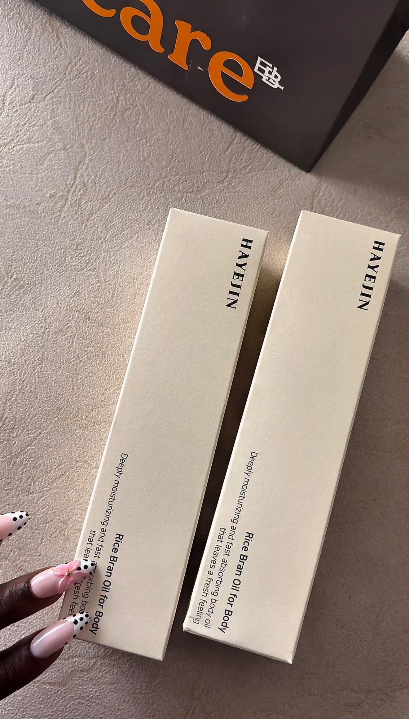 Two white boxes with text on a gray surface