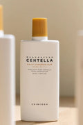 Sunscreen bottle labeled 'Madagascar Centella' on a neutral background