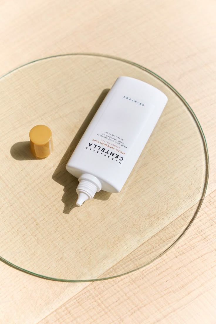 White bottle with a pump on a glass surface