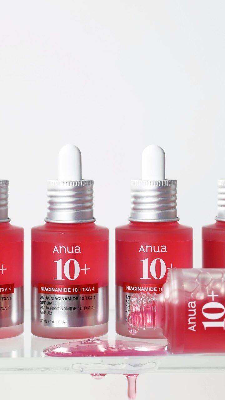 Set of Anua skincare bottles with white caps on a white background